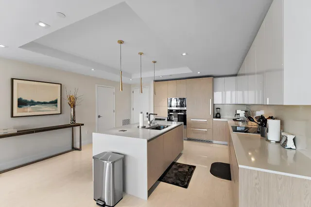 a kitchen with a sink a stove and cabinets