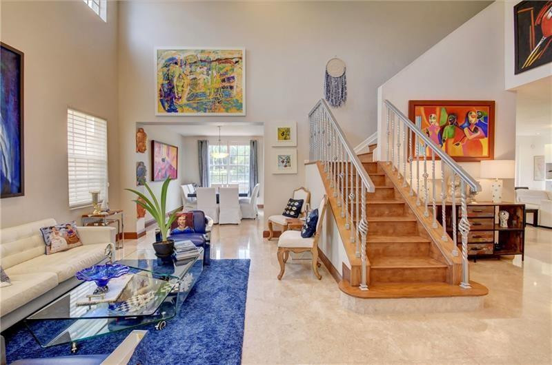 3863 Falcon Ridge Circle Weston, FL 33331 - Photo 12 of 52 a living room with furniture and stairs