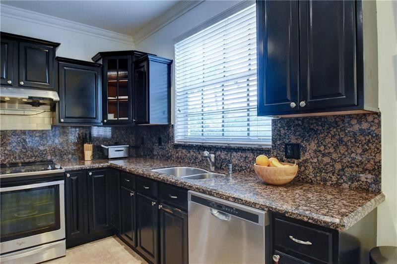 3863 Falcon Ridge Circle Weston, FL 33331 - Photo 16 of 52 a kitchen with a sink a stove and cabinets