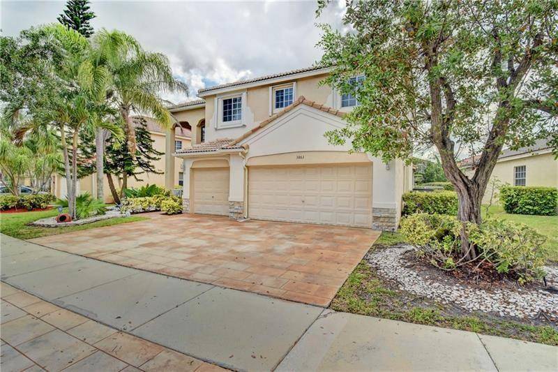 3863 Falcon Ridge Circle Weston, FL 33331 - Photo 18 of 52 front view of a house with a yard