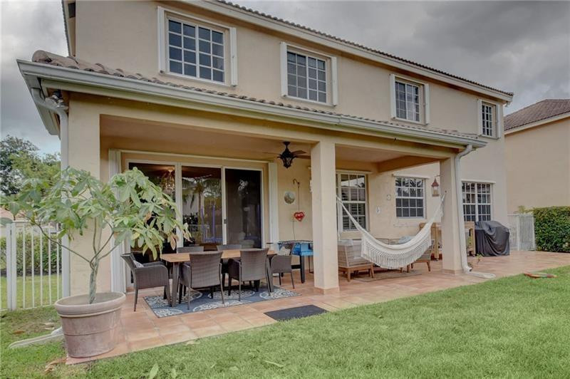 3863 Falcon Ridge Circle Weston, FL 33331 - Photo 24 of 52 a view of a patio with table and chairs and a barbeque