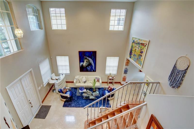 3863 Falcon Ridge Circle Weston, FL 33331 - Photo 34 of 52 a living room with furniture and stairs