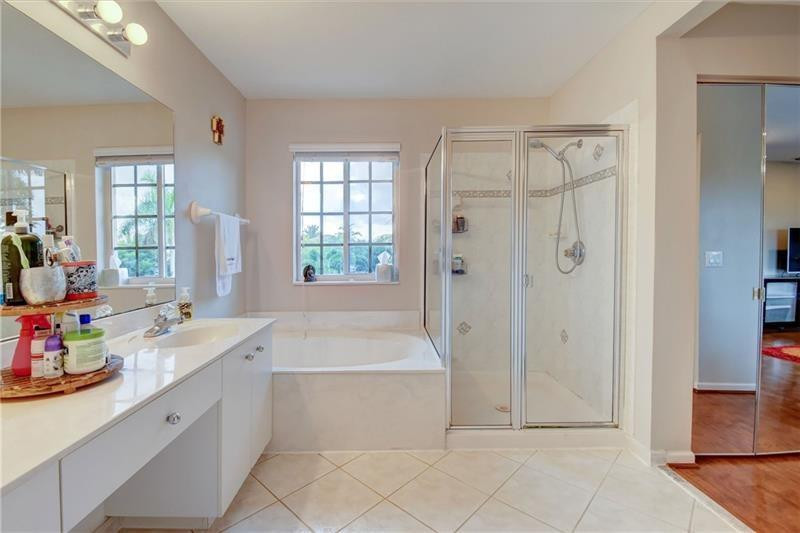 3863 Falcon Ridge Circle Weston, FL 33331 - Photo 46 of 52 a bathroom with a tub sink and a shower