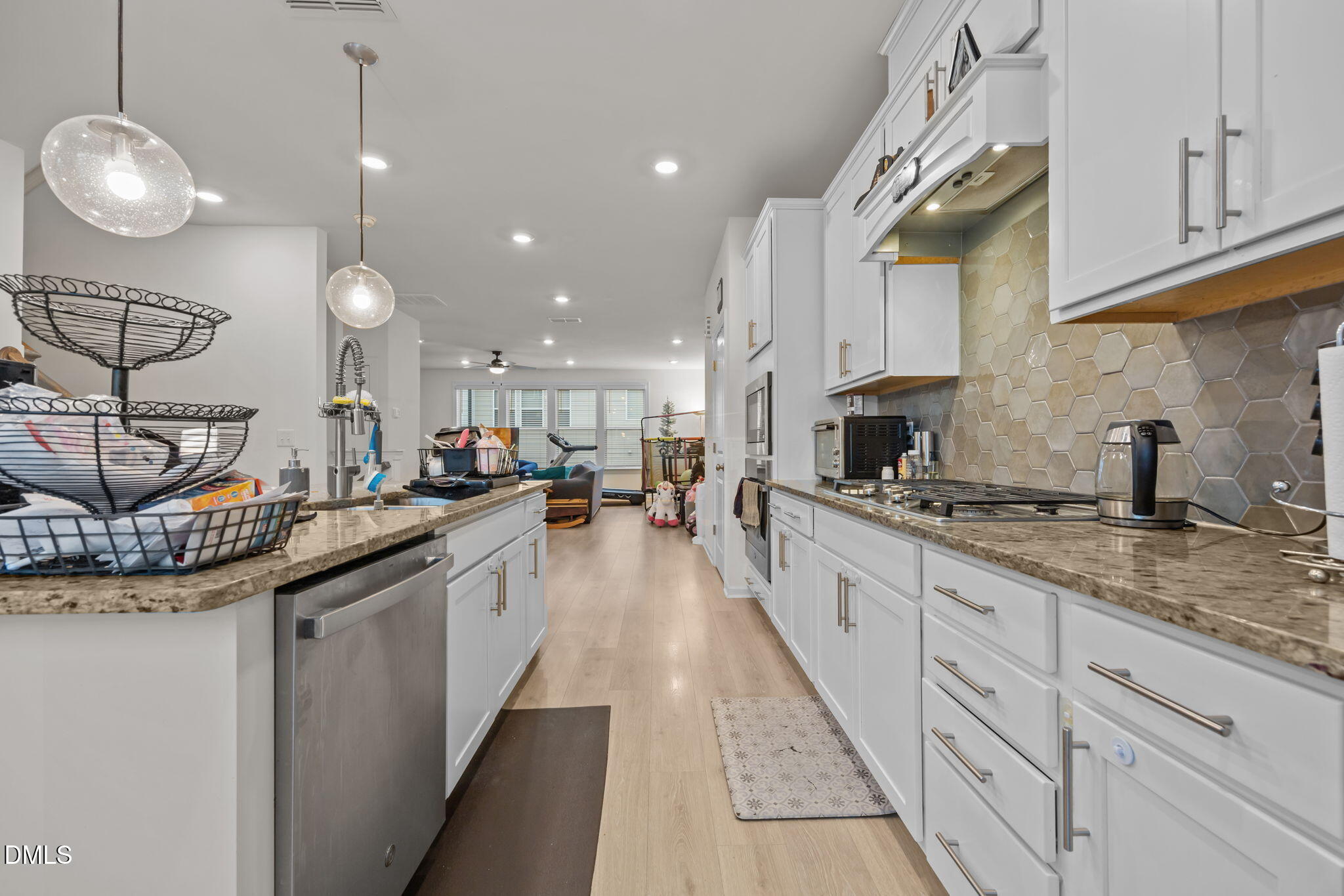 7015 Gentle Pine Place Raleigh, NC 27613 - Photo 12 of 41 a large kitchen with granite countertop a sink and cabinets