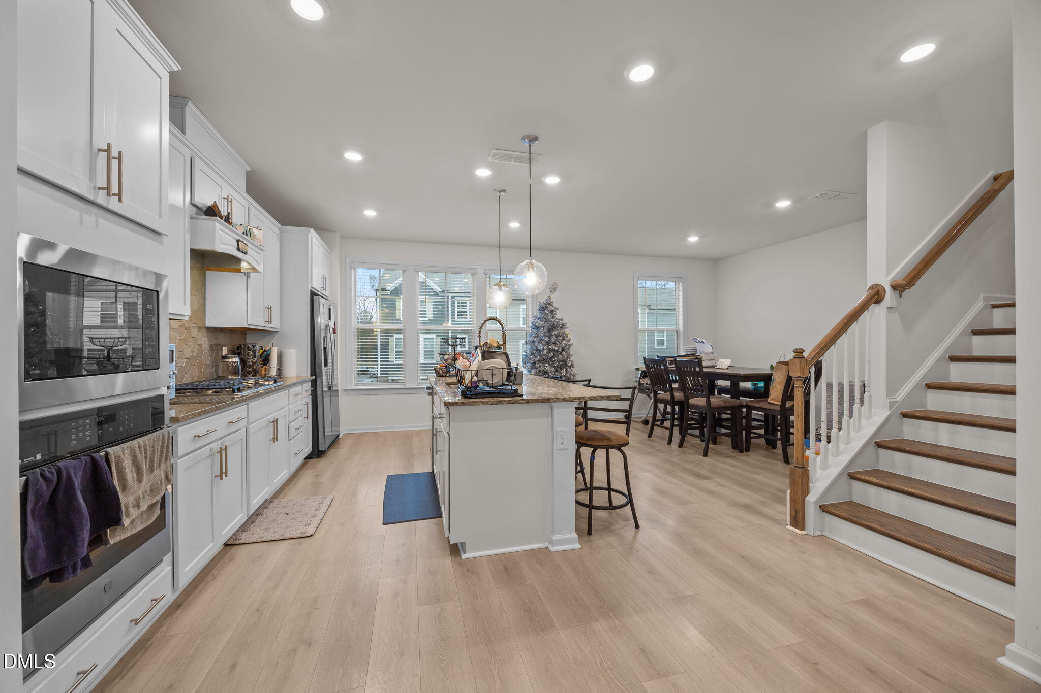 7015 Gentle Pine Place Raleigh, NC 27613 - Photo 13 of 41 a large white kitchen with lots of counter space a sink and stainless steel appliances