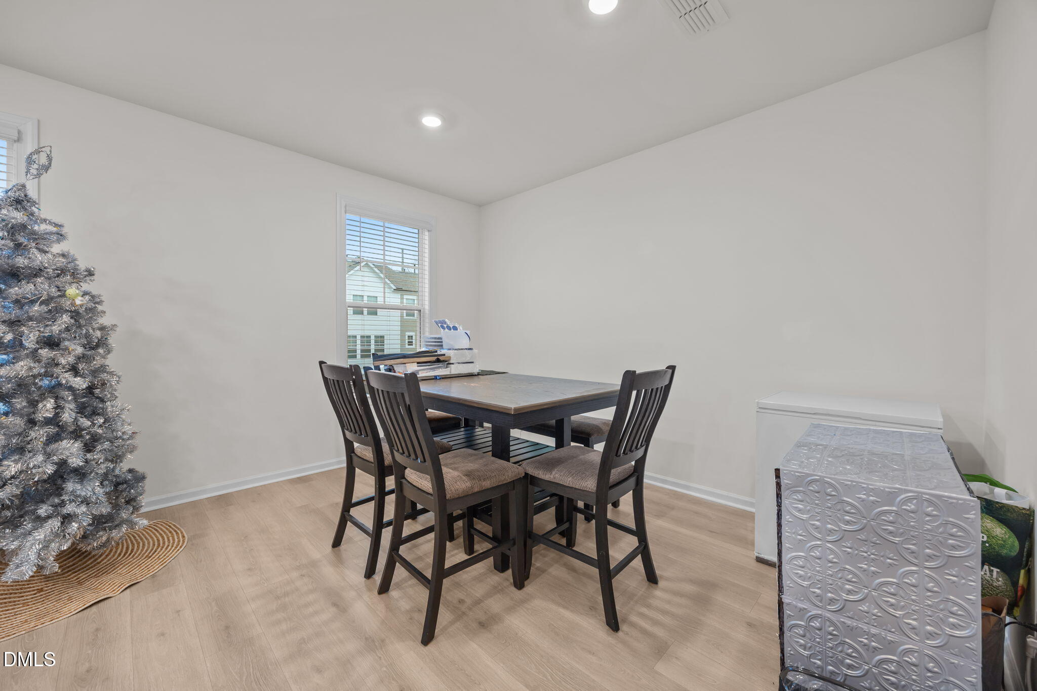 7015 Gentle Pine Place Raleigh, NC 27613 - Photo 14 of 41 a view of a dining room with furniture and wooden floor