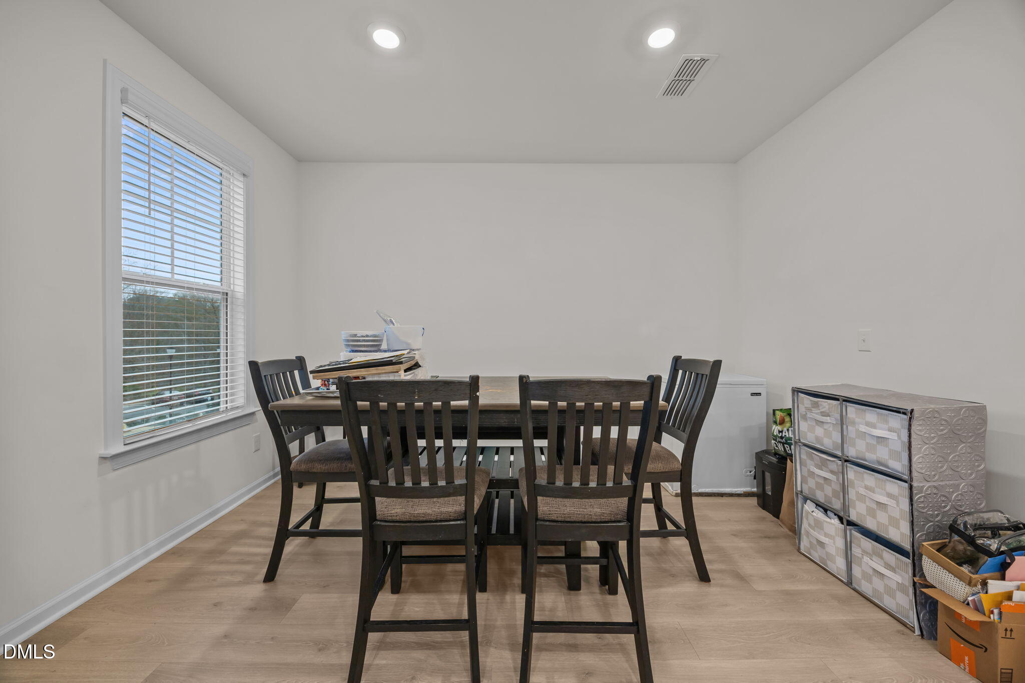 7015 Gentle Pine Place Raleigh, NC 27613 - Photo 15 of 41 a view of a dining room with furniture and wooden floor