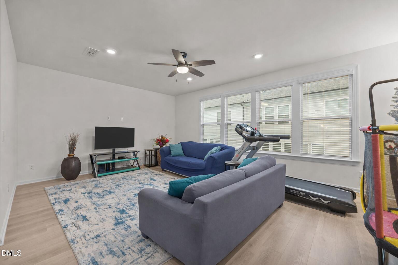 7015 Gentle Pine Place Raleigh, NC 27613 - Photo 17 of 41 a living room with furniture a flat screen tv and a window
