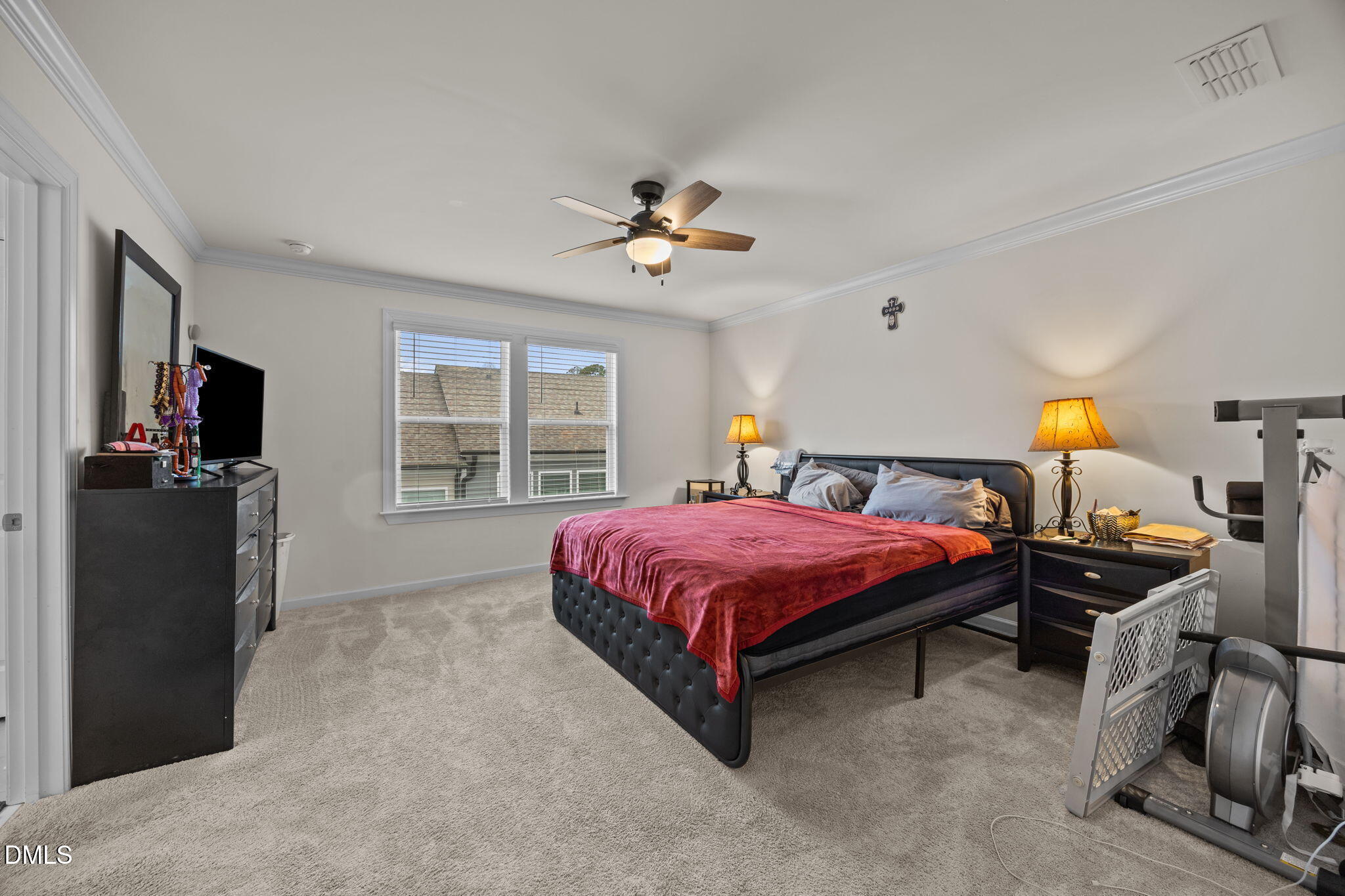 7015 Gentle Pine Place Raleigh, NC 27613 - Photo 19 of 41 a spacious bedroom with a bed and a chandelier