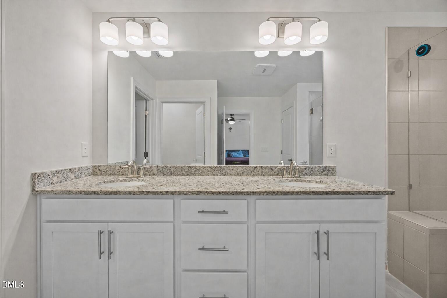 7015 Gentle Pine Place Raleigh, NC 27613 - Photo 22 of 41 a bathroom with a granite countertop double vanity sink and a mirror