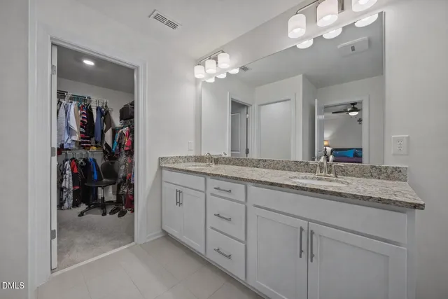 a bathroom with a double vanity sink and a mirror
