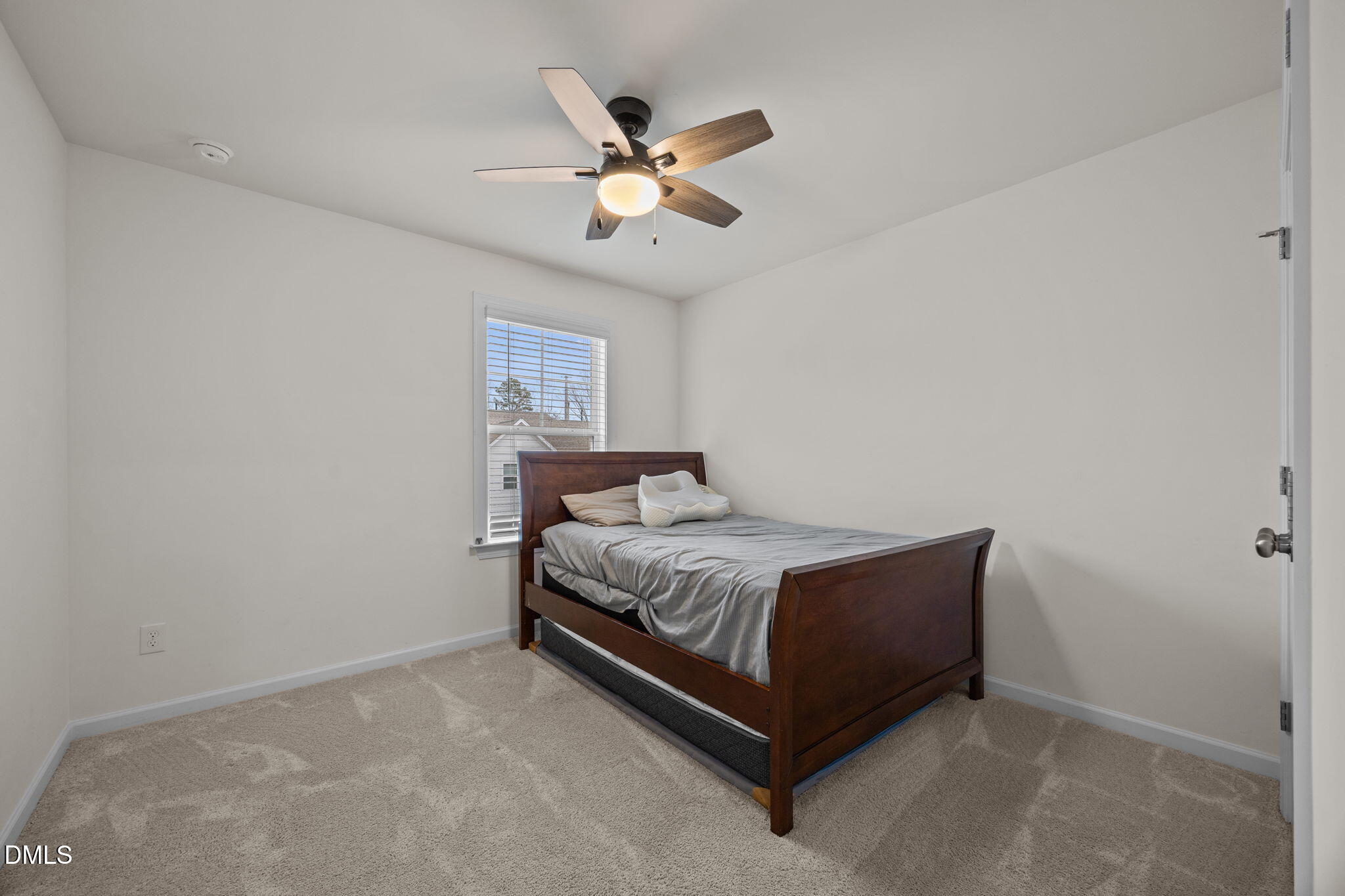 7015 Gentle Pine Place Raleigh, NC 27613 - Photo 24 of 41 a bed room with a bed and a ceiling fan