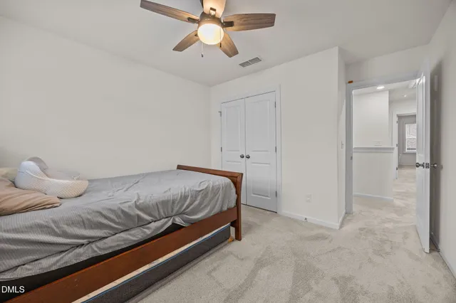 a bedroom with a bed and ceiling fan