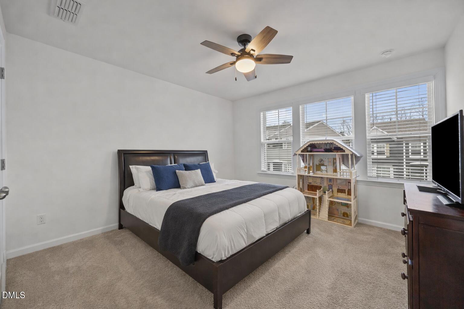 7015 Gentle Pine Place Raleigh, NC 27613 - Photo 26 of 41 a spacious bedroom with a bed and a flat screen tv