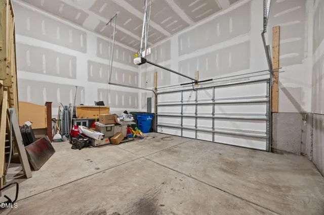 a view of garage with parked cars