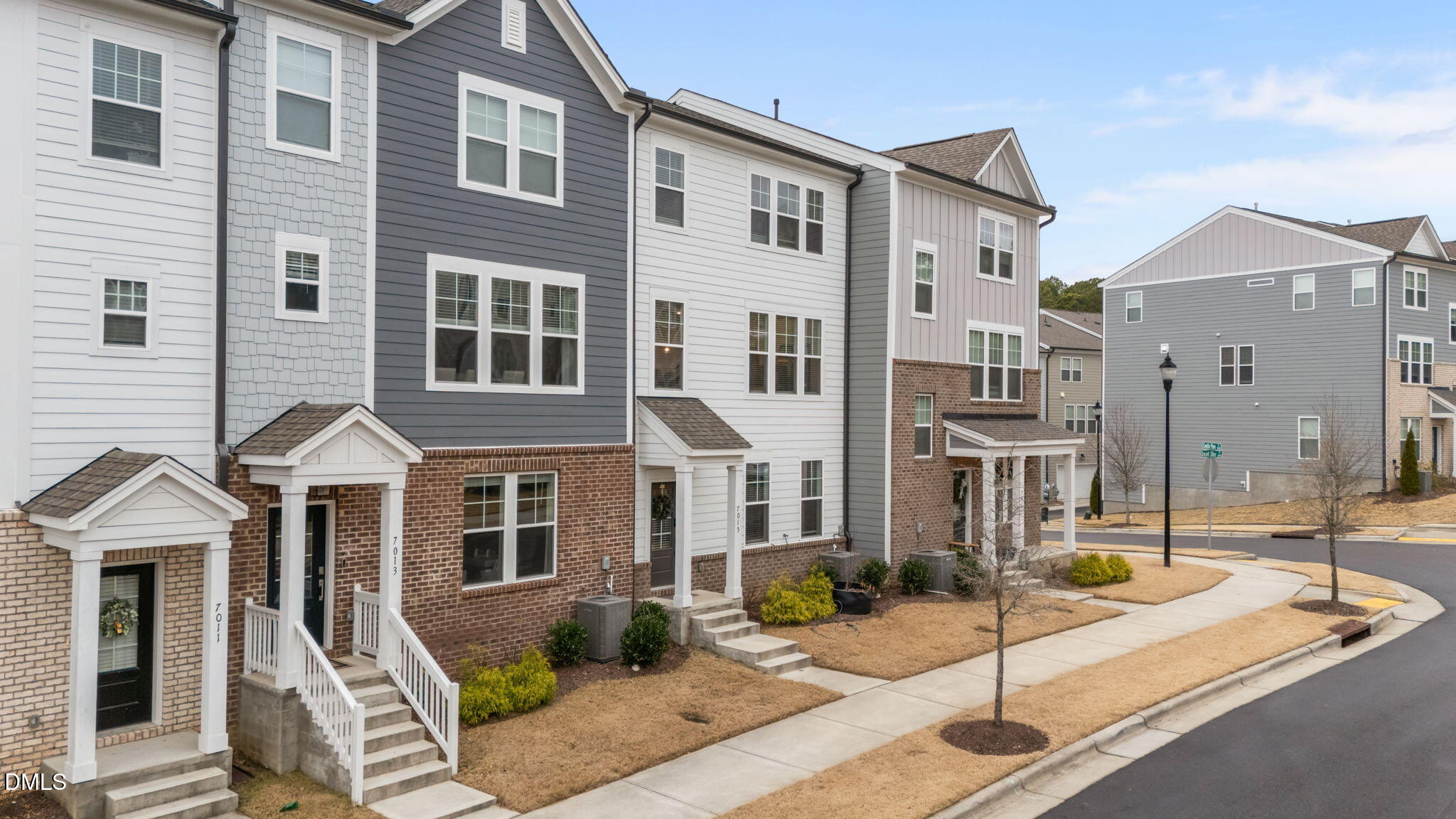 7015 Gentle Pine Place Raleigh, NC 27613 - Photo 31 of 41 a front view of a building with a garden and patio