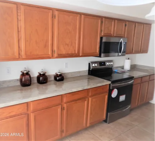 a kitchen with stainless steel appliances granite countertop a sink a stove and a microwave