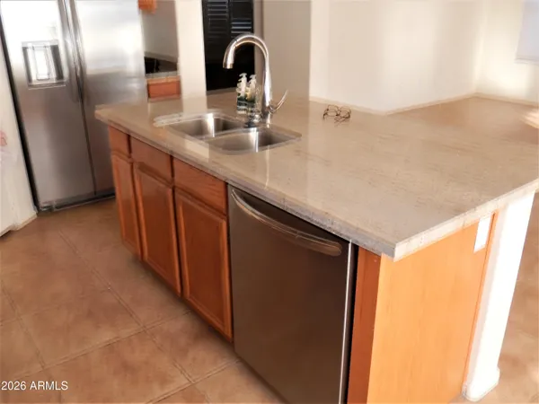a kitchen with stainless steel appliances a sink and a refrigerator