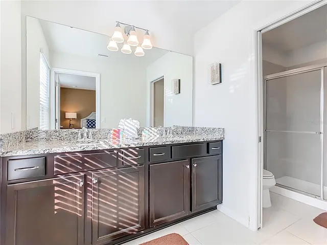 a view of a hallway with wooden floor and windows