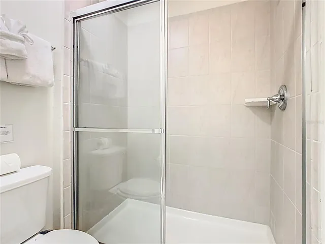 a bathroom with a bathtub a toilet and shower