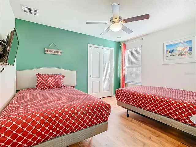 a large bed sitting in a bedroom next to a window