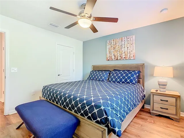 a bedroom with a bed and painting on the wall