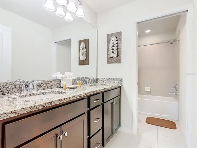 a bedroom with a bed and a flat tv screen on dresser
