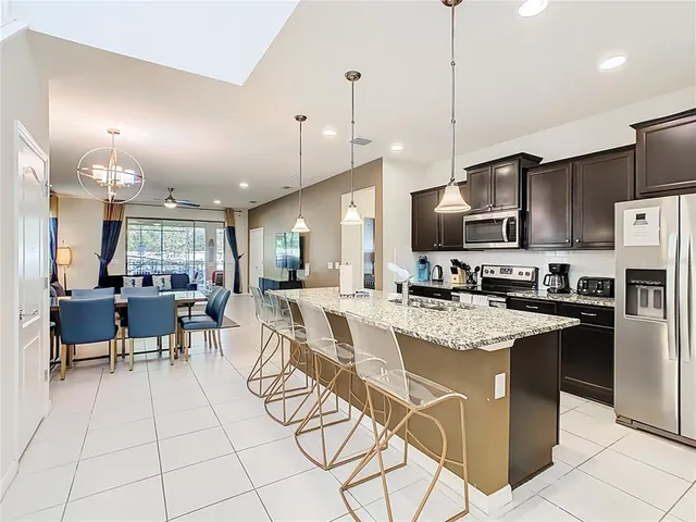 a kitchen with a sink a clock and cabinets