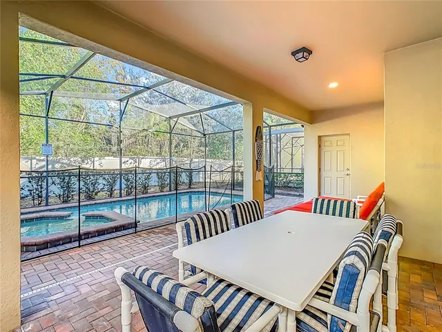 a living room with furniture potted plant and a large window