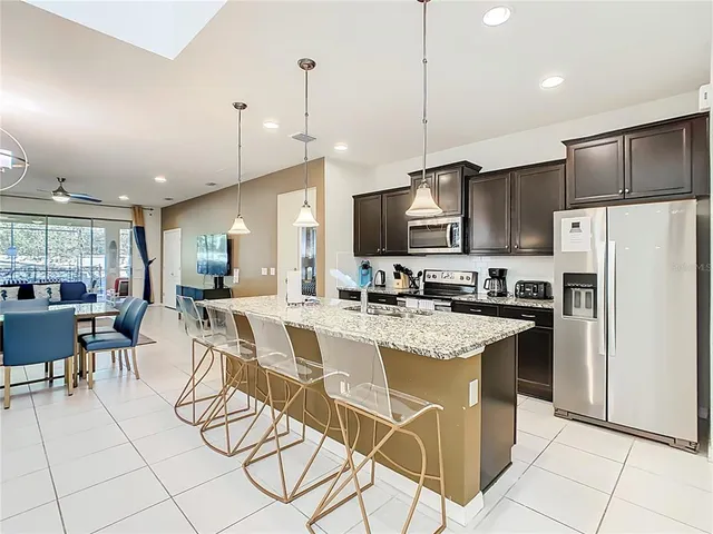 a living room with furniture a rug and a chandelier