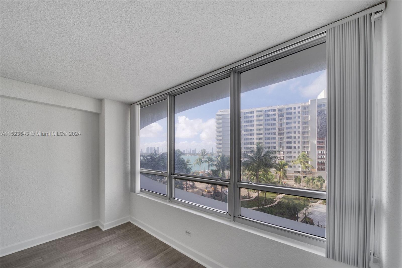 1500 Bay Road, Unit S0354 Miami Beach, FL 33139 - Photo 16 of 78 a view of a room with wooden floor and windows