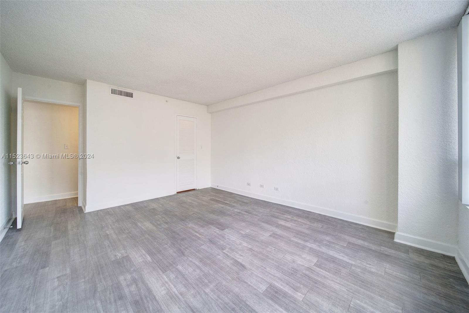 1500 Bay Road, Unit S0354 Miami Beach, FL 33139 - Photo 19 of 78 a view of empty room with wooden floor