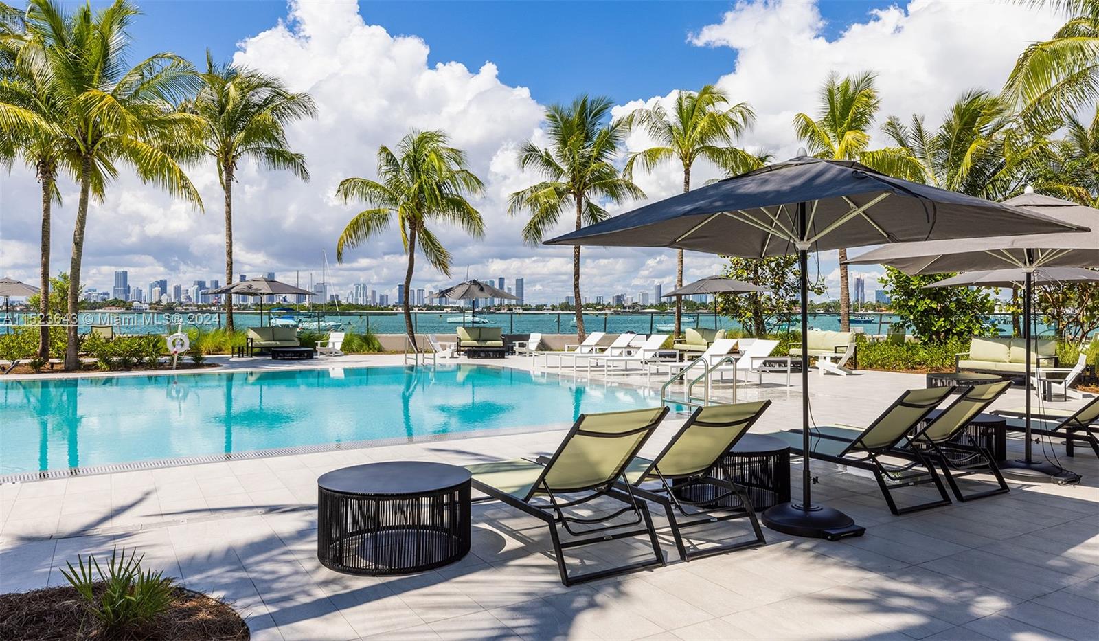 1500 Bay Road, Unit S0354 Miami Beach, FL 33139 - Photo 22 of 78 a view of a chairs and table in patio with a lake view
