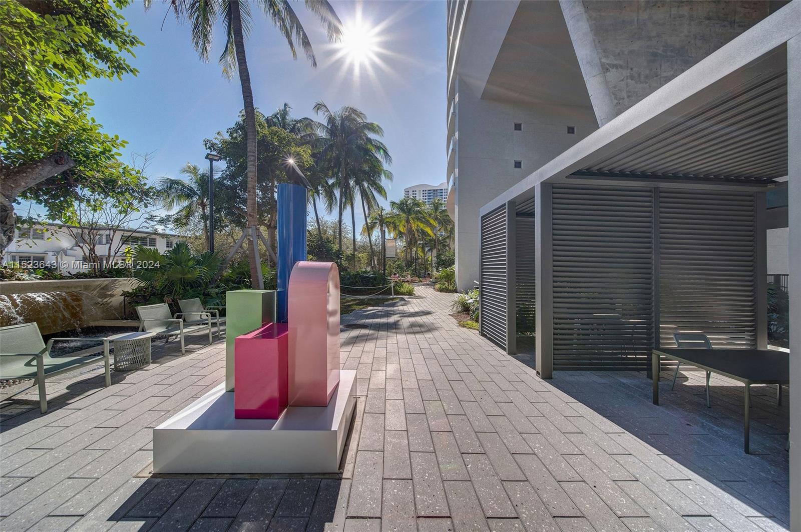 1500 Bay Road, Unit S0354 Miami Beach, FL 33139 - Photo 47 of 78 a patio with a table and chairs and potted plants