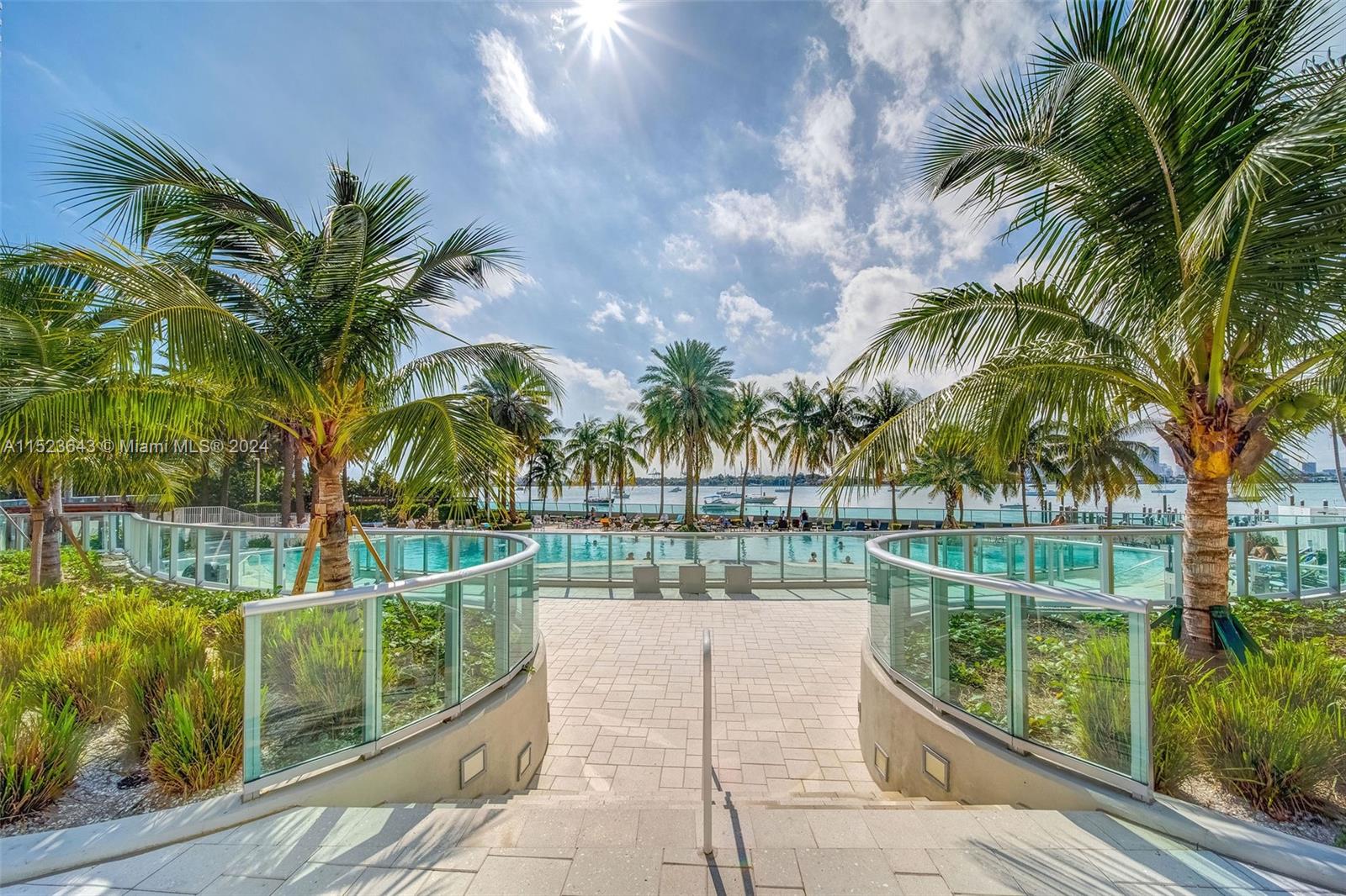 1500 Bay Road, Unit S0354 Miami Beach, FL 33139 - Photo 68 of 78 a view of a swimming pool with a patio and a yard