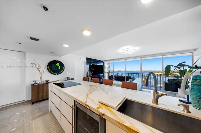 a kitchen with stainless steel appliances granite countertop a sink a stove and a wooden floors