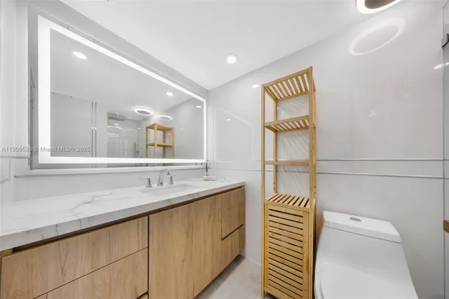 a bathroom with a sink a mirror and a shower