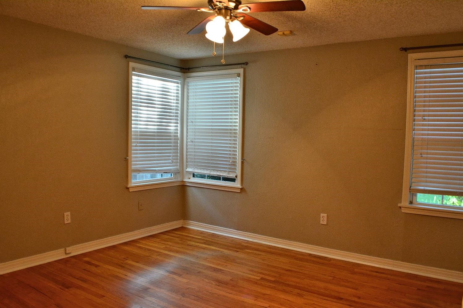 3213 26th Street Lubbock, TX 79410 - Photo 12 of 20 a view of an empty room with wooden floor and a window