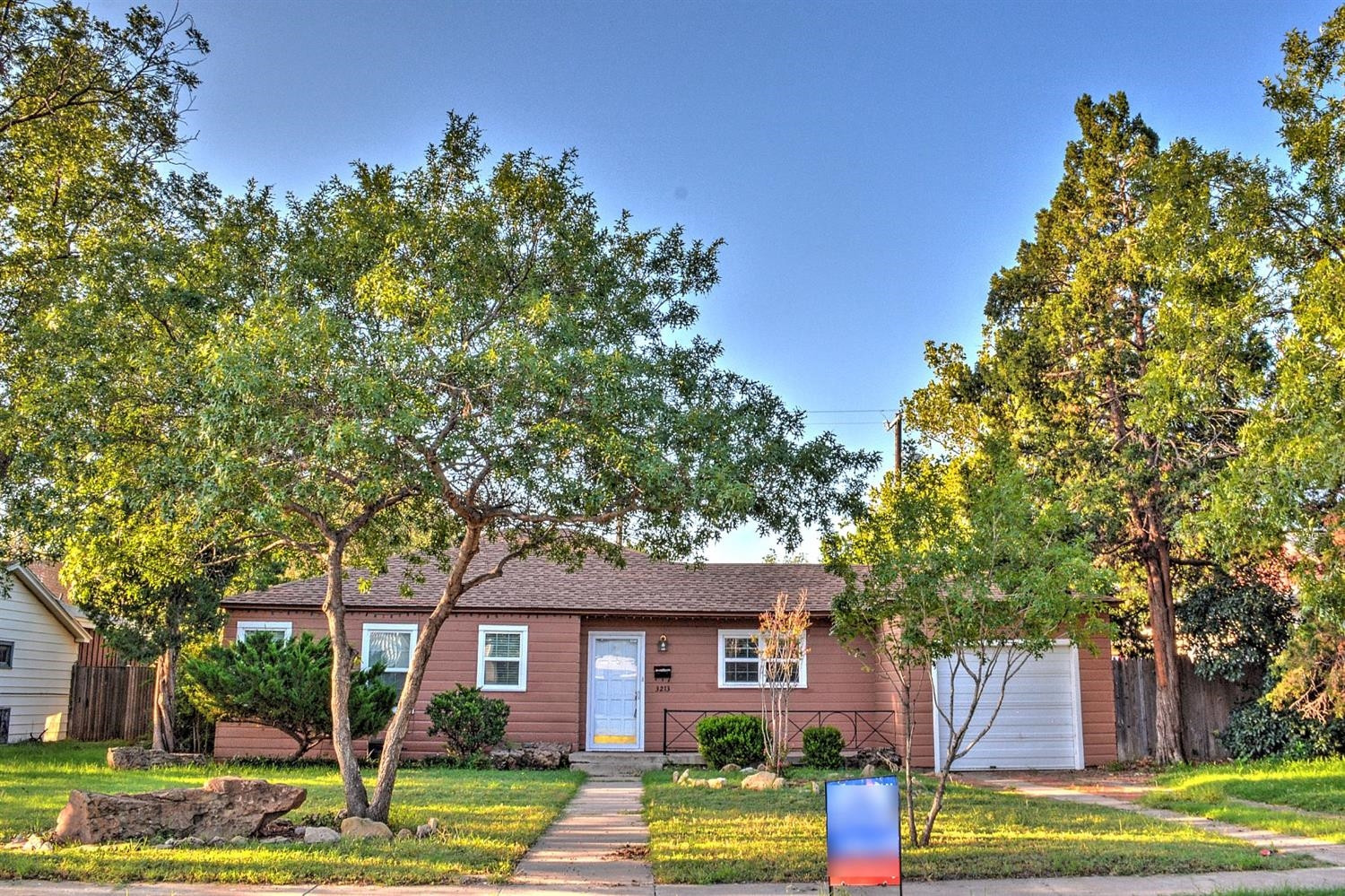 3213 26th Street Lubbock, TX 79410 - Photo 2 of 20 a front view of a house with garden