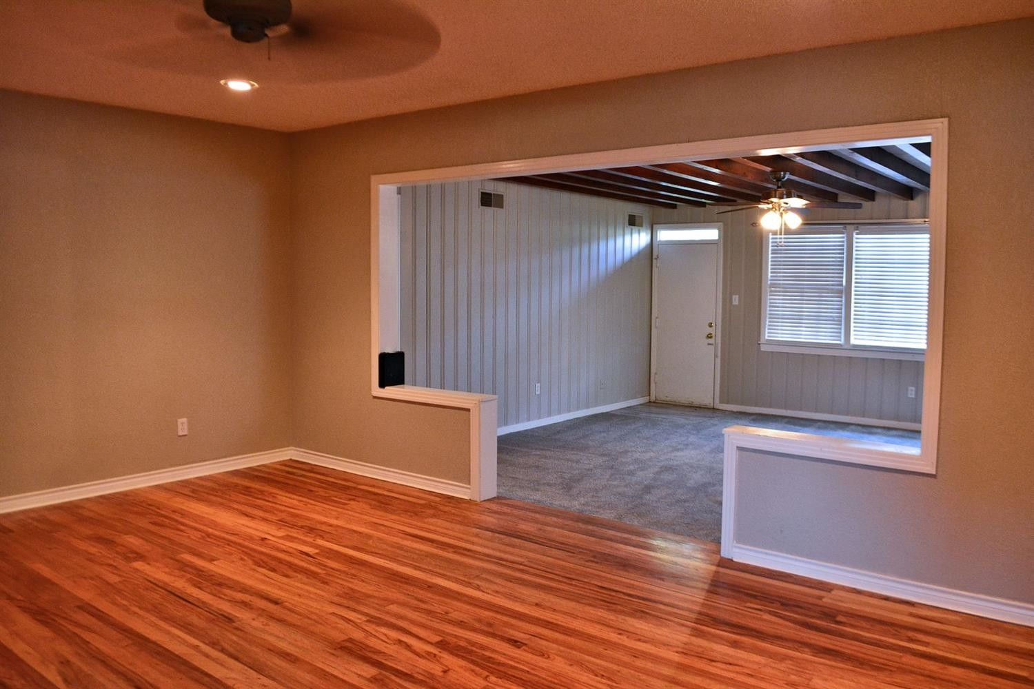 3213 26th Street Lubbock, TX 79410 - Photo 7 of 20 a view of an empty room with wooden floor and a window
