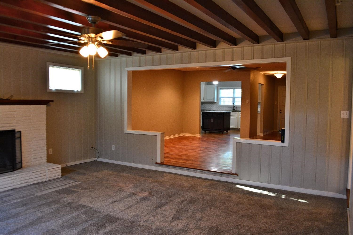 3213 26th Street Lubbock, TX 79410 - Photo 10 of 20 a view of an empty room with wooden floor and a fireplace
