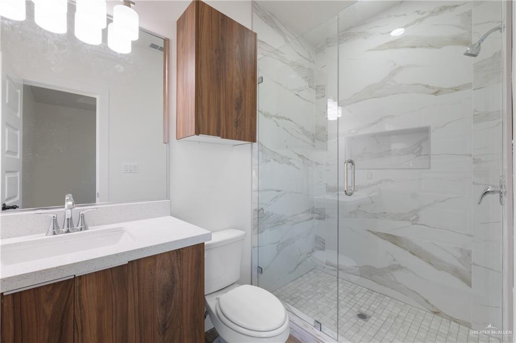 2902 Gabriel Street, Unit 1 Mission, TX 78574 - Photo 12 of 14 a bathroom with a sink a toilet and shower