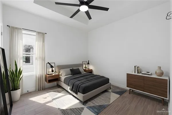 a bedroom with a bed and a potted plant