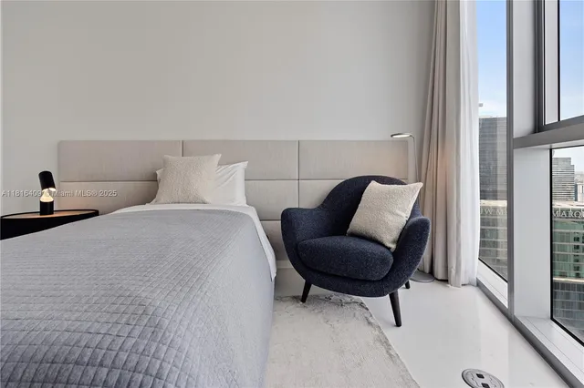 a bedroom with a bed and a chair