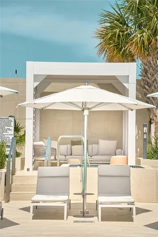 a balcony with dining table and chairs