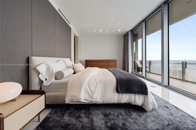 a bedroom with bed and glass door
