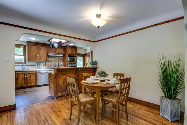 a kitchen with granite countertop a stove a sink and a refrigerator