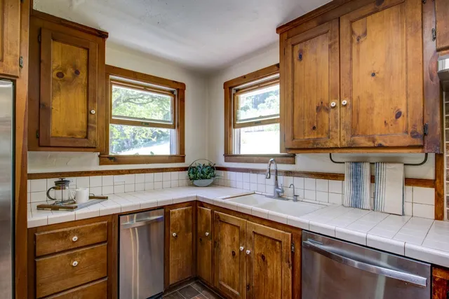 a spacious bathroom with a granite countertop sink and a large mirror