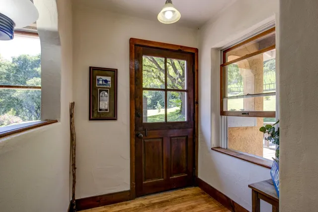 a view of a room with wooden floor and windows
