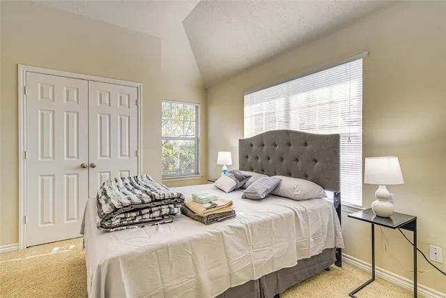 a bedroom with bed and window